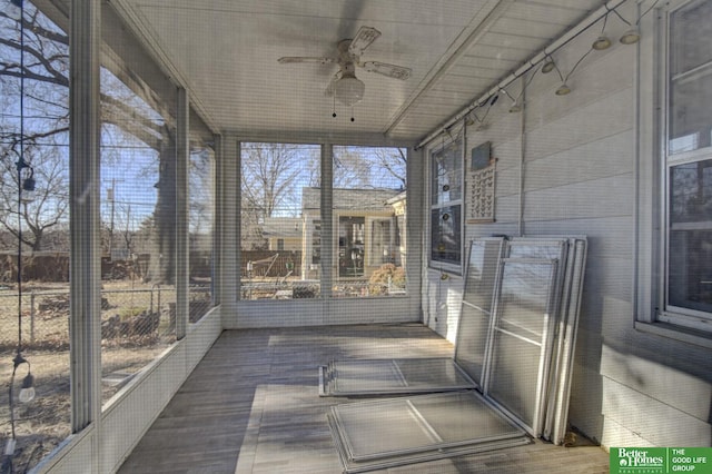 unfurnished sunroom with ceiling fan