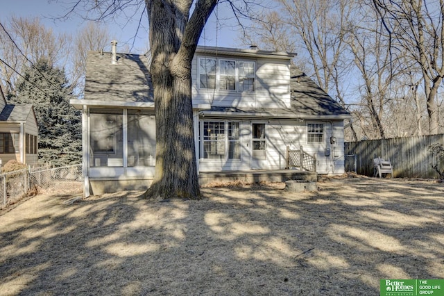 rear view of house featuring a sunroom