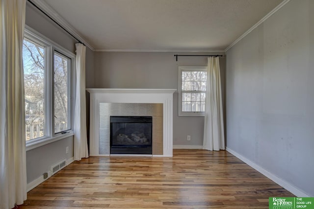 unfurnished living room with crown molding and light hardwood / wood-style floors