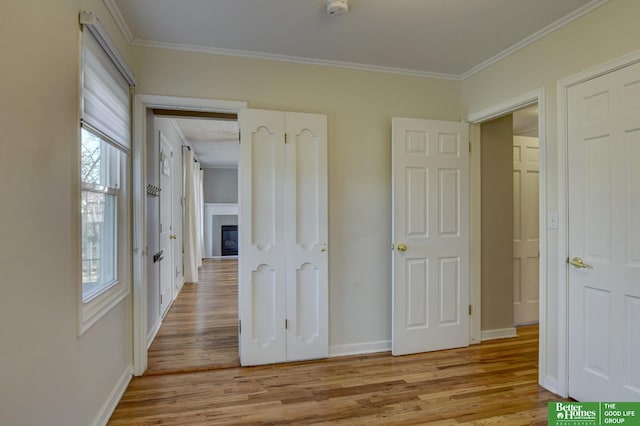 unfurnished bedroom featuring ornamental molding and light hardwood / wood-style floors