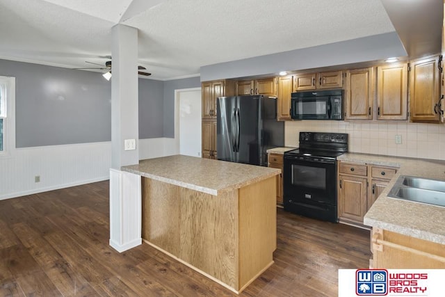 kitchen featuring dark hardwood / wood-style floors, kitchen peninsula, ceiling fan, decorative backsplash, and black appliances