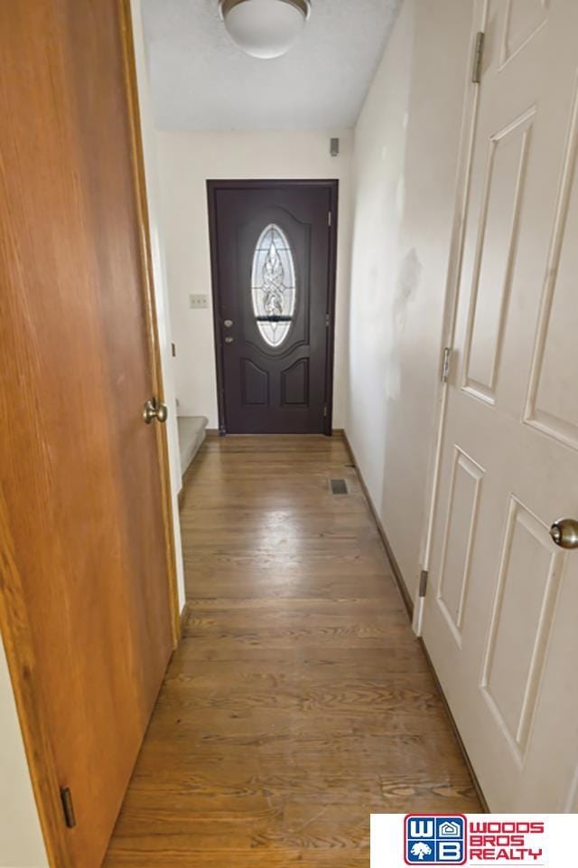 doorway to outside with light wood-type flooring