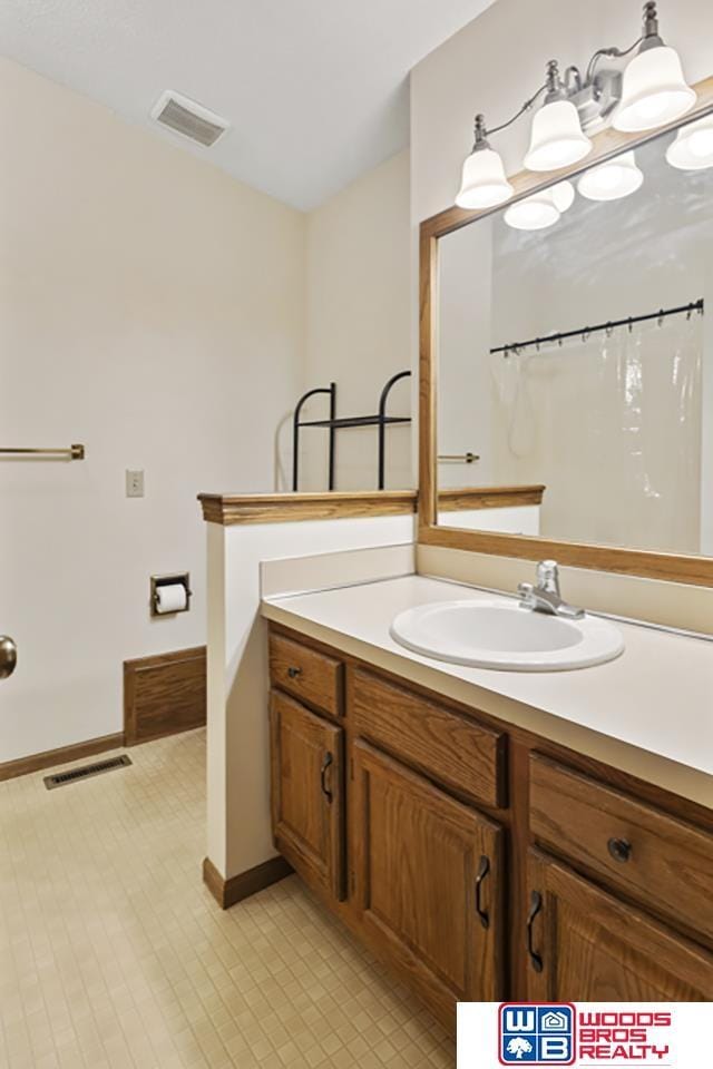 bathroom with vanity and curtained shower