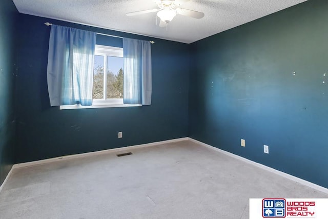 spare room with ceiling fan, carpet floors, and a textured ceiling