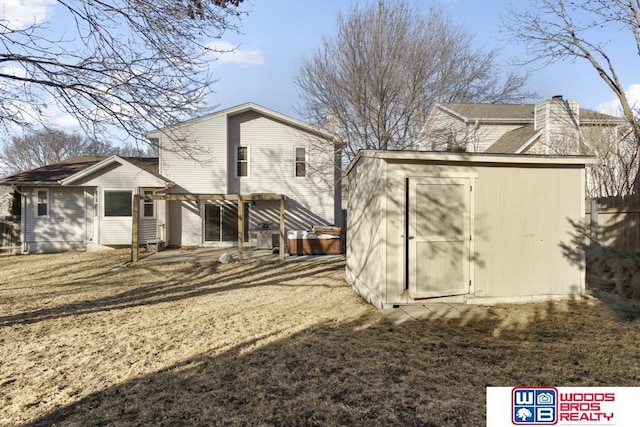 rear view of house featuring a pergola, a shed, and a lawn