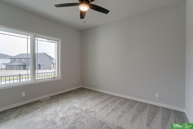 empty room with ceiling fan and carpet flooring