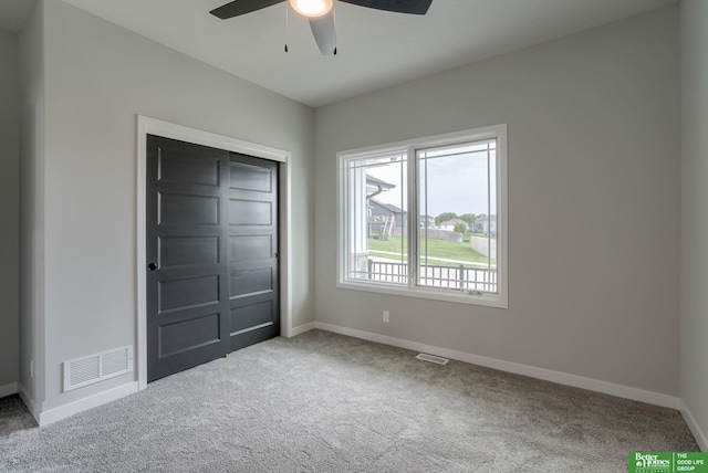 unfurnished bedroom with carpet floors, a closet, and ceiling fan