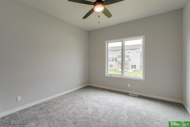 carpeted spare room with ceiling fan