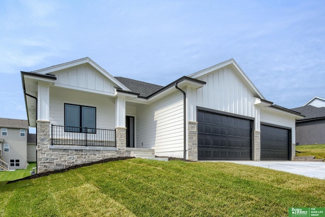 view of front facade with a garage, a front lawn, and covered porch