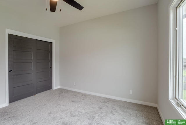 unfurnished bedroom with light carpet and ceiling fan