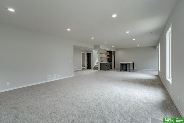 unfurnished living room with light carpet