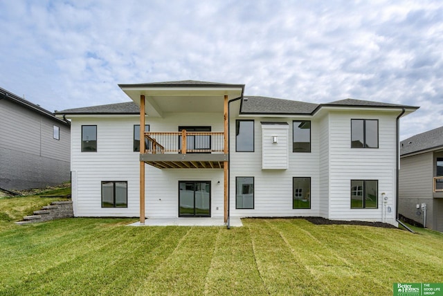 back of house featuring a yard, a patio, and a balcony