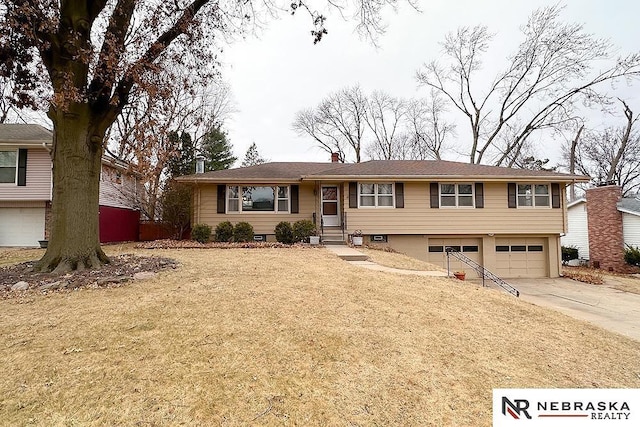 view of front of property featuring a garage and a front lawn