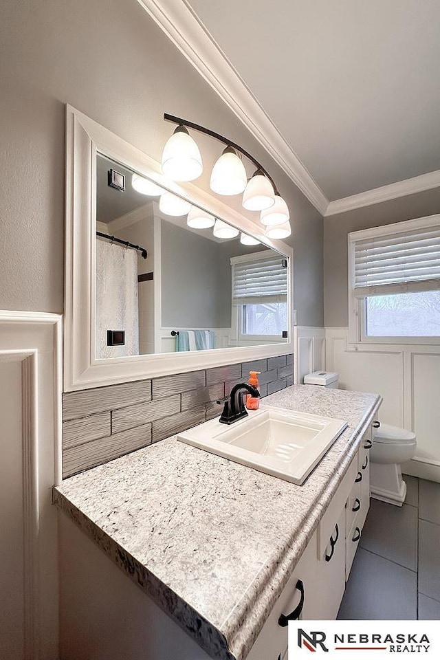 bathroom with ornamental molding, toilet, tile patterned flooring, and vanity