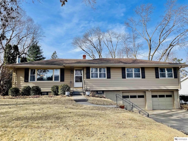 view of front of property with a garage and a front yard