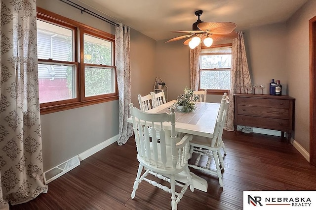 dining space with dark wood-type flooring and ceiling fan