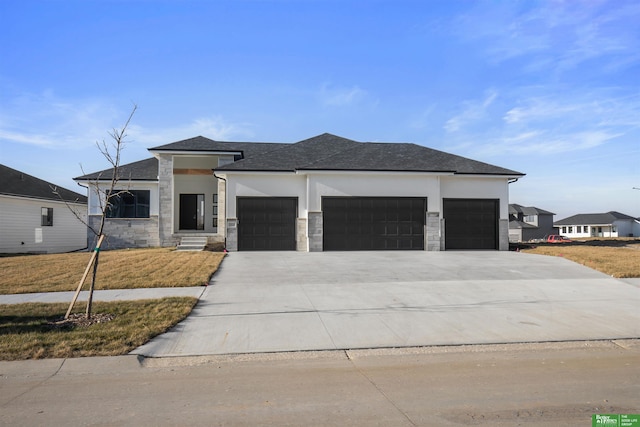 prairie-style home featuring a garage and a front yard