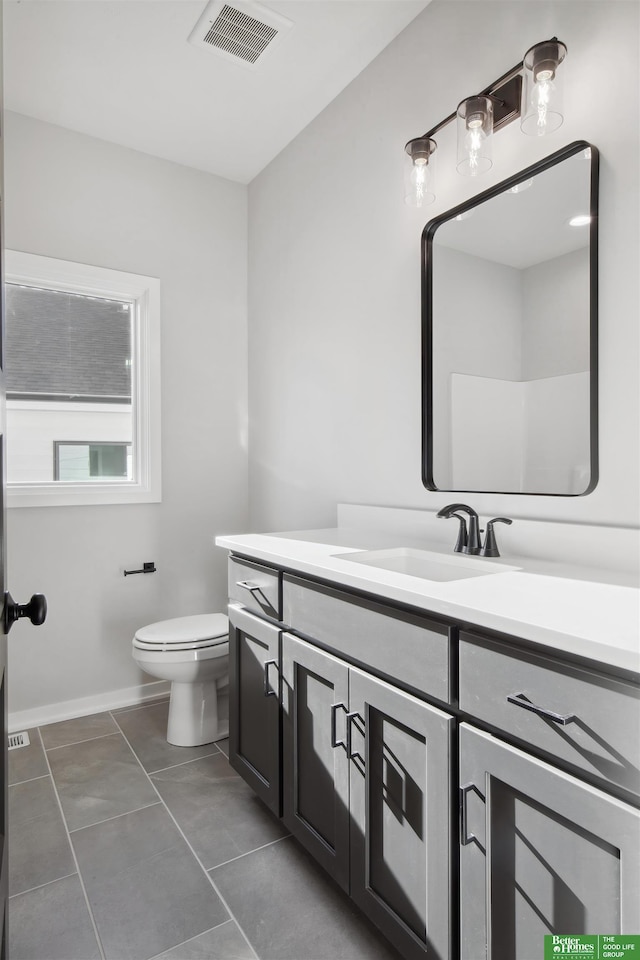 bathroom with vanity, tile patterned floors, and toilet