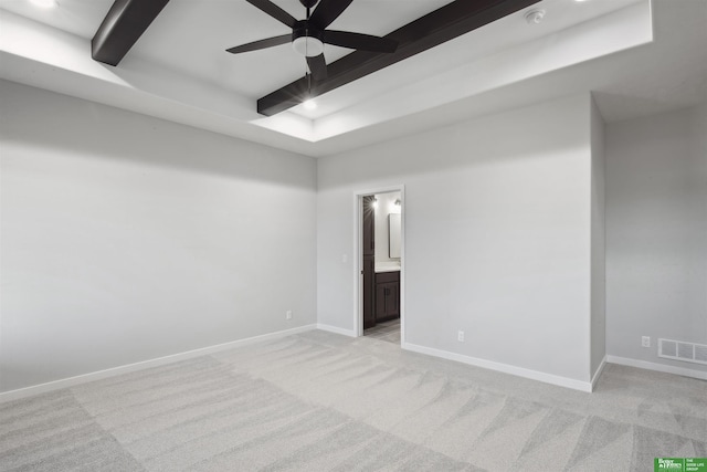 carpeted empty room with ceiling fan and beam ceiling