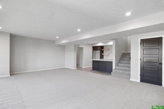 unfurnished living room featuring light carpet