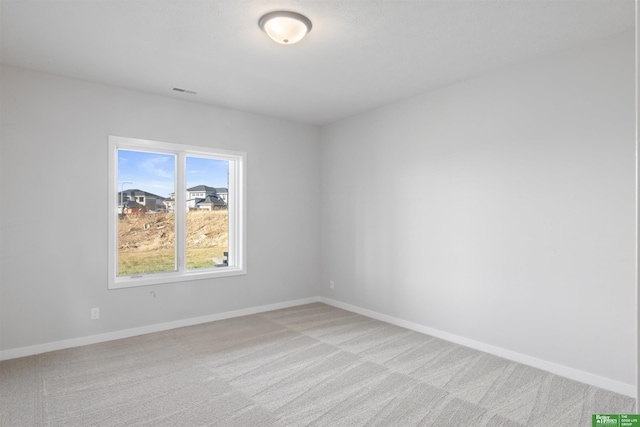 spare room with light colored carpet