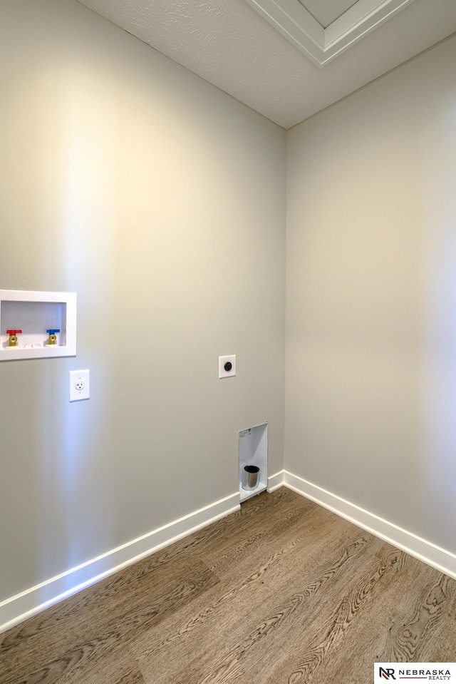 clothes washing area with washer hookup, hardwood / wood-style floors, and electric dryer hookup