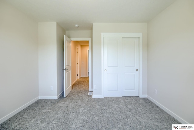 unfurnished bedroom with a closet and carpet