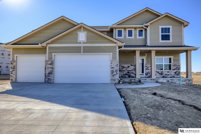 craftsman inspired home with a garage and a porch