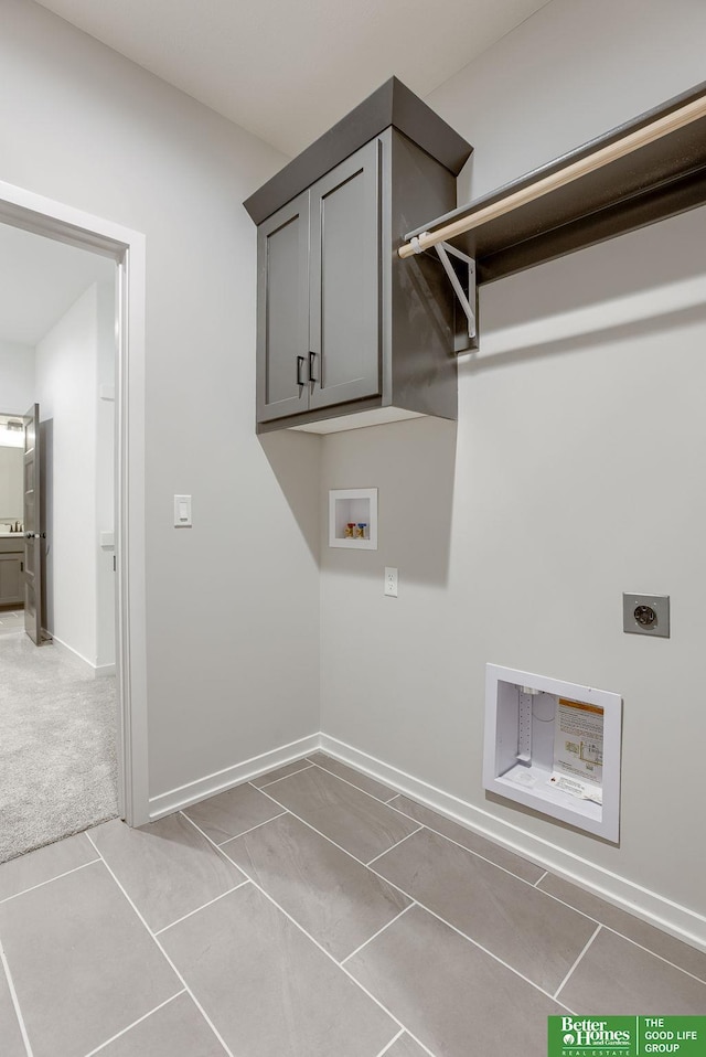 laundry room featuring cabinets, hookup for a washing machine, hookup for an electric dryer, and light tile patterned floors