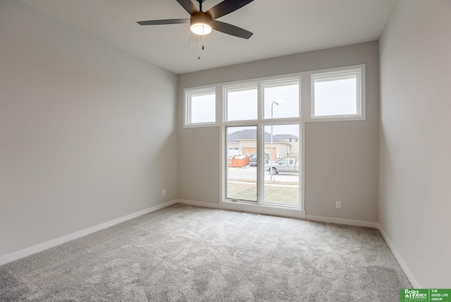 empty room with ceiling fan and carpet flooring