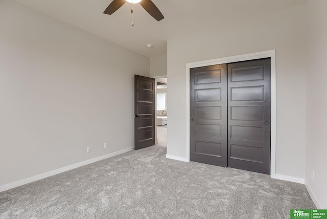 unfurnished bedroom featuring ceiling fan, carpet flooring, and a closet