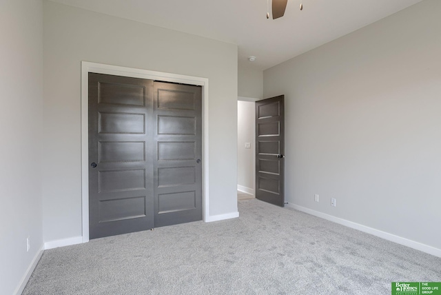 unfurnished bedroom with carpet, ceiling fan, and a closet