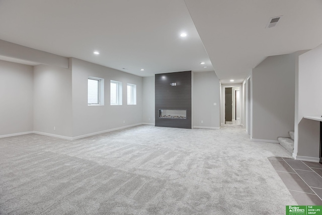 unfurnished living room with light carpet and a fireplace