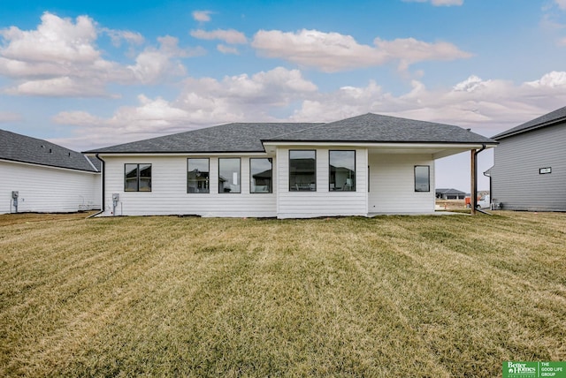 rear view of property with a lawn