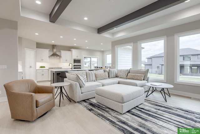 living room featuring sink and beam ceiling