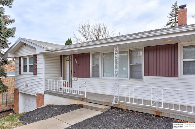 view of front of property with a garage and covered porch