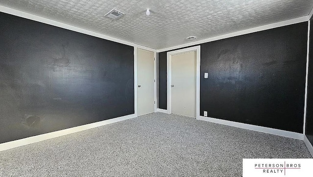 unfurnished room featuring a textured ceiling