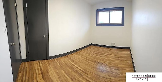 spare room featuring hardwood / wood-style flooring