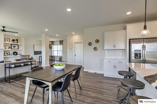 dining space with dark hardwood / wood-style floors and ceiling fan