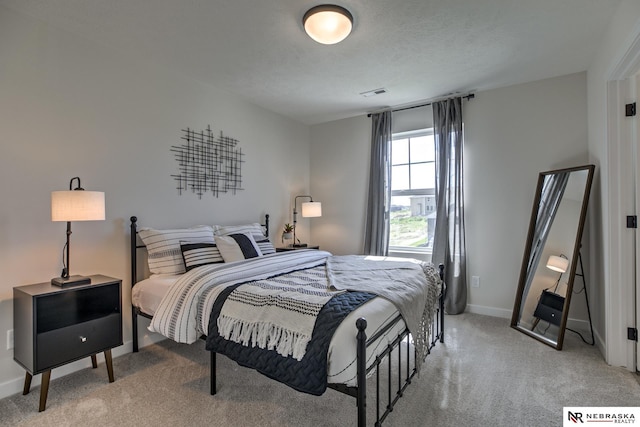 carpeted bedroom featuring a textured ceiling