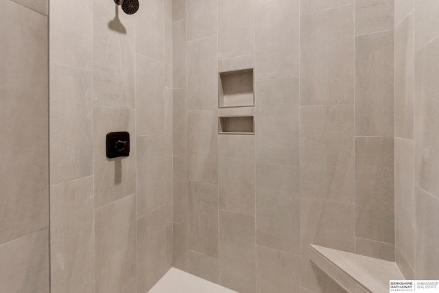 bathroom with a tile shower