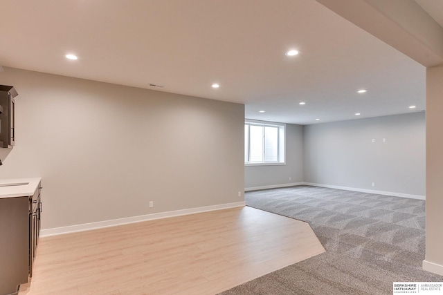 interior space featuring sink and light hardwood / wood-style flooring