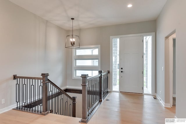 foyer with a chandelier and light hardwood / wood-style flooring