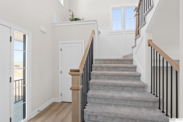 stairs with hardwood / wood-style floors