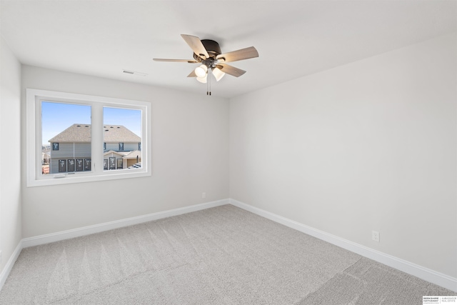 unfurnished room featuring ceiling fan and carpet flooring