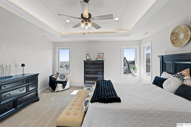 carpeted bedroom with crown molding, ceiling fan, and a tray ceiling