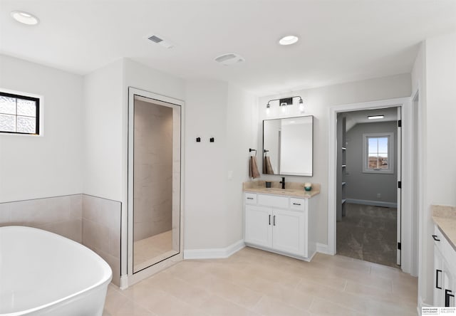 bathroom featuring tile patterned floors, vanity, and plus walk in shower