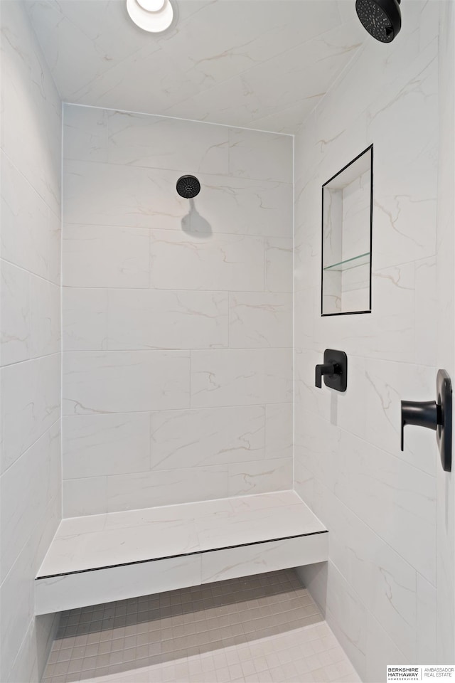 bathroom with a tile shower