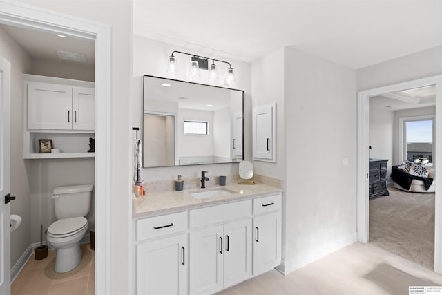 bathroom with tile patterned flooring, vanity, and toilet