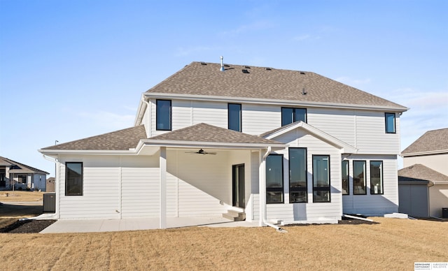 back of property featuring ceiling fan, a yard, and a patio